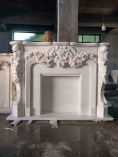 a white fireplace sitting in the middle of a room