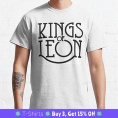 a man wearing a t - shirt with the words kings of leon printed on it