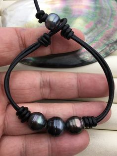 "Quantity: 1pc Real Drop tahitian pearl, pearl size 11-13mm, this pearl is real tahitian pearl,natural color. Back clasp is one freshwater pearl,if you like tahitian pearl,can custom to make. Bracelet is 6''-10.5''  long All tahitian leather bracelet  jewelry: https://www.etsy.com/hk-en/shop/WenPearls?ref=seller-platform-mcnav&search_query=Le10 All tahitian leather necklace jewelry: https://www.etsy.com/hk-en/shop/WenPearls?ref=seller-platform-mcnav&search_query=Le11 Back to Other Jewelry Section 01: \"Tahitian,Akoya,Sea Pearl\" Section: https://www.etsy.com/shop/WenPearls?section_id=15806339 02: \"Potato/Near Round Pearl\" Section: https://www.etsy.com/shop/WenPearls?section_id=16378067 03: \"Round Pearl\" Section: https://www.etsy.com/shop/WenPearls?section_id=16163245 04: \"Rice/Oval/Te Leather Pearl Jewelry, Make Bracelet, Leather Cord Bracelets, Tahitian Black Pearls, Big Three, Big Pearl, Leather Art, Wire Work Jewelry, Pearl Leather