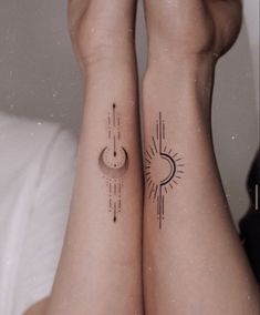 two people with matching tattoos on their legs, both have sun and moon tattoo designs