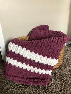 there is a purple and white crocheted blanket on the floor