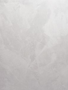 a white marble wall textured with light grey paint