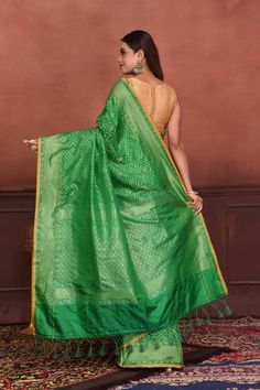 Radiate elegance on festive occasions in this beautiful green Katan silk Banarasi saree with over all zari work. The saree has yellow edging. It comes with a matching blouse piece. Disclaimer: The shown stitched blouse on the model is for display purpose only. The saree comes with a matching blouse piece and finished with fall and piko Disclaimer: The actual product may vary slightly from the image. These are custom orders, hence expect slight variation in color, placement of the motif or buta. Green Slub Silk Lehenga For Navratri, Green Anarkali Traditional Wear In Slub Silk, Green Slub Silk Anarkali Traditional Wear, Green Tussar Silk Pre-draped Saree With Dupatta, Traditional Green Slub Silk Pre-draped Saree, Green Tussar Silk Pre-draped Saree, Green Anarkali Slub Silk Dupatta, Anarkali Green Slub Silk Dupatta, Festive Green Slub Silk Traditional Wear