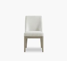 a white chair against a white background with the seat upholstered to it's back