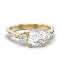 three stone engagement ring in yellow gold with an oval diamond center and two round diamonds on the side