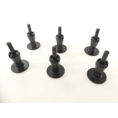 six black plastic cup holders on white background