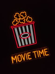 a neon sign that says movie time in front of a black background