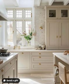 a white kitchen with lots of counter space and cabinets in it's center island