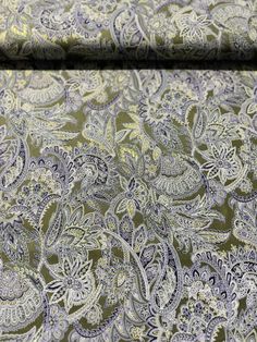 a green and blue paisley print fabric