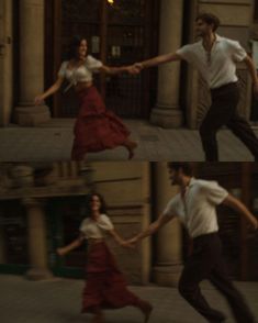 the man and woman are dancing together on the sidewalk in front of an old building