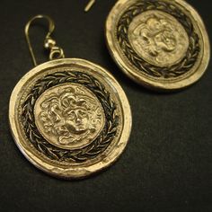 "Handmade gorgon Medusa cameo museum earrings, Gorgone Meduse, perfect gift for fans of Percy Jackson. This cameo represents the head of Medusa placed on a shield by Theseus and given to Athena to use during battle for protection. It was then later used by knights on their shields and the front of castles for protection. - Handmade cameo reproduction. - Solid yellow bronze cameo, also called jeweler gold bronze - 14K gold filled ear wire. - Gold filled has 100 times more gold than plated thus do Handmade Antique Plug Earrings As Gift, Handmade Medallion Earrings For Gift, Handmade Medallion Earrings As Gift, Ceremonial Round Earrings With Oxidized Finish, Ceremonial Gold Earrings With Oxidized Finish, Round Oxidized Earrings For Ceremonial Occasions, Round Earrings With Oxidized Finish For Ceremonial Occasions, Symbolic Earrings With Oxidized Finish For Gift, Handmade Symbolic Earrings