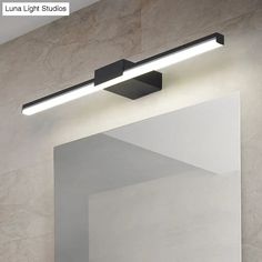 a bathroom mirror with lights above it