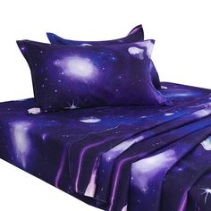 a bed covered in purple sheets and pillows with stars on the sky above them,