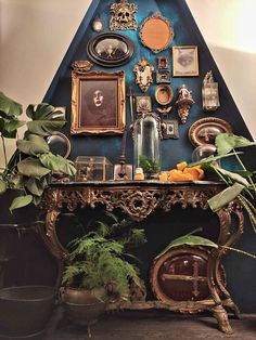 there is a table with pictures and plants on it