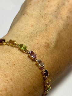 This genuine bright red garnet, citrine, blue topaz, amethysts, and peridot bracelet is very lively and bright. The stones are deep colors natural stones The sterling silver is plated with rhodium to protect the bracelet from tarnish 7.5 in Our jeweler can shorten it for $20 All jewelry is shipped free in the US in a nice gift box. Check out our over a THOUSAND great reviews Engraving is $4 per letter and is not always perfect depending on the piece. It can take a few days if the jeweler is busy Formal Multicolor Natural Gemstones, Elegant Multicolor Sterling Silver Bracelet With Stones, Elegant Multicolor Gemstone Sterling Silver Bracelet, Elegant Multicolor Stones Sterling Silver Bracelet, Multicolor Gemstone Sterling Silver Bracelet, Amethyst Multi-stone Bracelet Gift, Elegant Multicolor Birthstone Bracelets, Elegant Multicolor Birthstone Bracelet, Multi-stone Amethyst Bracelet