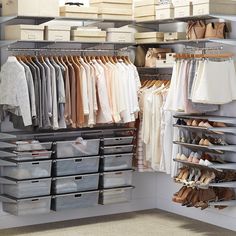 an organized closet with clothes, shoes and boxes on the shelves in front of it