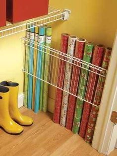 a pair of yellow rain boots sitting on top of a wooden floor next to books