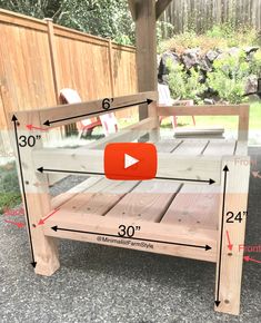 a wooden bench sitting on top of a cement ground