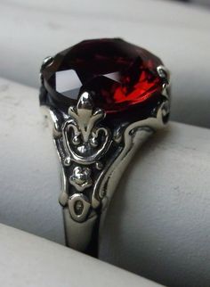 Simulated Red Ruby ring Paws Design#115 Custom made This is a Victorian reproduction ring in sterling silver with a lovely red gemstone. This high quality flawless Man-made red ruby has great shine and a lovely captivating color. The full cut approx. 3ct gemstone is 10mm (3/8th of an inch) in diameter. The inside of the band is marked 925 for sterling. Notice the beautiful floral antique design of the silver filigree setting and band. A gift ring box is included and all rings are shipped in the Classic Red Ruby Jewelry, Red Gemstone Rings In Sterling Silver, Classic Red Jewelry With Lab-created Ruby, Classic Red Birthstone Jewelry, Classic Red Lab-created Ruby Jewelry, Classic Red Birthstone Ring, Classic Red Round Jewelry, Classic Red Jewelry With Round Cut, Red Sterling Silver Round Rings