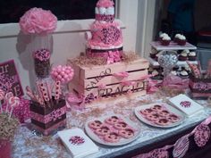 a table topped with lots of pink desserts