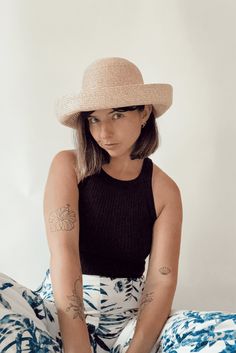 Whether you're attending rowing regattas, enjoying summer picnics, or leisurely drifting down the river, our woven raffia straw hat is the perfect companion. Featuring a timeless dome boater style with a charming flipped edge, it effortlessly combines elegance with a laid-back vibe. This is the epitome of the relaxed yet refined look we're all embracing this year. COUTONIC VINTAGE COLLECTION The COUTONIC Vintage Collection is not just a fashion collection; it's a sustainability-conscious homage Spring Coastal Boater Hat Made Of Toquilla Straw, Chic Spring Boater Hat Made Of Paper Straw, Brimmed Crochet Hat For Spring Warm Weather, Brimmed Crochet Hat For Spring And Warm Weather, Spring Crochet Hat With Short Brim For Warm Weather, Spring Crochet Hat With Flat Brim For Warm Weather, Short Brim Boater Hat In Paper Straw For Spring, Spring Short Brim Boater Hat In Paper Straw, Coastal Straw Sun Hat For Spring