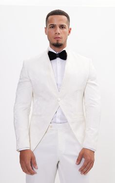 DETAILS This white tailored fit tuxedo is a unique and stylish option for any special or formal event. Features a raised laced texture of the fabric that creates depth and dimension, adding a tactile element to the jacket. Designed with a mandarin collar. which adds a touch of modernity to the jacket. As well as having a satin finish around the closure, giving a luxurious sheen to the outfit. Pair with any Tomson Tuxedo Pants SIZE + FIT Tailored fit, to find your correct size use the ''What's my Tailored White Tuxedo For Party, White Long Sleeve Tuxedo For Party, White Notch Lapel Blazer For Groom, White Tuxedo Blazer For Grooms, White Tuxedo Blazer For Groom, White Tuxedo Blazer For Evening, Luxury White Suit For Parties, White Tailored Long Sleeve Tuxedo, White Tailored Long-sleeved Tuxedo