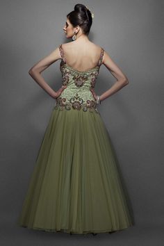 This dusky green color Indo western bridal gown has pink & green resham work, with silver & gold zircons and silver swirls in the centre. The form is fitted through the body with a soft voluminous net & dupion silk flair. Embellished Green Tulle Ball Gown, Green Embellished Tulle Ball Gown, Green Organza Dress For Reception, Green Evening Dress With Fitted Bodice And Sweetheart Neckline, Green Embellished Ball Gown For Party, Green Floor-length Organza Evening Dress, Green Organza Ball Gown Evening Dress, Green Tulle Evening Gown, Elegant Green Organza Ball Gown