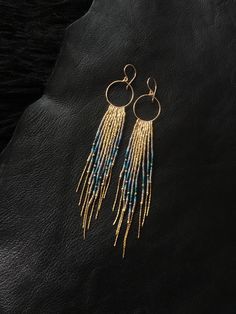 "Maui Swan Designs beautiful, glamorous long Glass Beadwork and handmade 14K gold filled Hoop Earrings with 14K gold filled chain fringe. Indigenous inspired glass seed bead earrings. Original design using tiny Czech glass seed beads hand sewn beautifully together with 14K gold filled chain and handmade Hoop, silver lined glass seed beads, 14K gold filled twisted buggle beads & nylon thread coated in Maui beeswax to maintain strength. 5\" long delicate earrings incorporating tones of gold , Dangle Beaded Earrings With 14k Gold Filled, Bohemian Beaded 14k Gold Filled Earrings, Bohemian 14k Gold Filled Beaded Dangle Earrings, Bohemian 14k Gold-filled Beaded Dangle Earrings, 14k Gold-filled Dangle Beaded Earrings With Gold Beads, Bohemian 14k Gold Filled Beaded Earrings, 14k Gold Filled Dangle Beaded Earrings With Gold Beads, 14k Gold-filled Beaded Dangle Earrings, Bohemian 14k Gold-filled Beaded Earrings