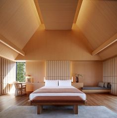 a large bed sitting inside of a bedroom on top of a hard wood floor