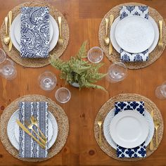 the table is set with plates and place settings