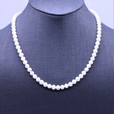 "This classic necklace is made with medium size 6mm high quality genuine AAA grade natural freshwater pearls. These natural pearl gemstones have a superior polish, are perfectly calibrated, and are uniform in size. - Not dyed, treated or color enhanced. 100% natural. - Photos taken outside in natural lighting and in a light box. - No filters or color enhancements are added to the photos. The 6mm round pearl beads are strung on strong micro woven stainless steel beading wire with nylon coating. I Classic Pearl Necklace With Round Beads And Pearl Drop, Classic Pearl Necklace With Polished Beads, Classic Pearl Necklace With Round Pearl Drop, Classic Pearl Necklaces With Polished Beads, Classic Pearl Necklaces With Round Beads, Classic Necklace With Pearl Pendant, Classic Beaded Necklace With Pearl Pendant, Classic Pearl Beaded Necklace With Pearl Pendant, Classic Pearl Pendant Beaded Necklace