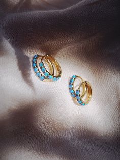 The prettiest blue opal hoops to sweeten your earlobes. These gold and cerulean blue opal huggie hoops shimmy and dance in the light day and night. Team them with with each other or mix and match with our other favorite hoop earrings. ✦ Choose your pair from two different sizes ✦✦ DETAILS ✦✧ Name: Kehaulani (keh-HOU-lah-nee) - Dew from the sky.✧ You will receive 1 pair.✧ Size 1: 10.5 x 2.25mm thick; 8.25mm inner diameter.✧ Size 2: 12.5 x 2.25mm thick; 9.75mm inner diameter.✧ Gold Plated Sterling Blue Huggie Hoop Earrings, Blue Small Hoop Huggie Earrings, Blue Hypoallergenic Small Hoop Huggie Earrings, Hypoallergenic Blue Small Hoop Huggie Earrings, Blue Hoop Huggie Earrings Gift, Blue Huggie Hoop Earrings As Gift, Blue Huggie Hoop Earrings For Gift, Blue Huggie Hoop Earrings For Pierced Ears, Opal Huggie Hoop Earrings Gift