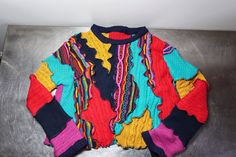 Reworked Textured Multi Sweater, size XL. ❤️DESCRIPTION: One of a kind, upcycled knit top.  Gorgeous and impactful in red, blue, teal, fuchsia and yellow.  A send up to classic Coogi style. Textured knit with an organic feel to the pattern.  Front, back, and sleeves feature textured designs.  Make it your own! ❤️MEASUREMENTS: * size XL * 44 inch bust * 22 inches long * 100% recycled lambs wool, cotton, acrylic ❤️SHIPPING: Immediate shipping worldwide; buy with confidence. ❤️MY SHOPS: Click this Colorful Patchwork Casual Sweater, Colorful Casual Patchwork Sweater, Red Patchwork Sweater, Red Knit Sweater With Patchwork, Red Patchwork Knit Sweater, Blue Knit Sweater With Patchwork, Colorful Patchwork Top For Fall, Multicolor Cotton Jacquard Knit Sweater, Multicolor Knit Patchwork Tops