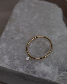 14k Gold dainty ring with beautiful diamond in a drilled jump ring setting.This gorgeous minimalist diamond solitaire ring features a .1ct round brilliant diamond on a dainty ring as if the diamond was naked.Diamond is Genuine and Conflict Free10 point diamond weighs 0.1 ct.,about 3mm. SI1 clarity and H-I color.Perfect Gift for her! Diamond Solitaire Ring, Solid Gold Ring, Delicate Design, Solid Gold Rings, Ring Setting, Diamond Solitaire Rings, Dainty Ring, Brilliant Diamond, Jump Rings