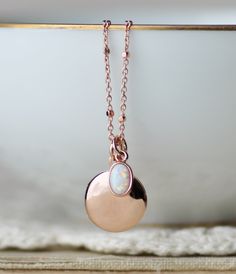 "A sweet new locket made with rose gold and an opal charm. Locket is rose gold plated and hangs from dainty rose gold plated chain. A small opal charm hangs off the side. See details and lengths below. * Locket - 13mm (1/2\") * Singapore chain -Adjusts to 18\" and 20\" only (has small ring to connect clasp at 18\" and 20\" lengths along chain) * Satellite Chain - Adjusts from 16-18\", or 18-20\" * Opal charm - Lab created opal, 6x4mm Please choose desired chain style and length at checkout. List Choker Collar Necklace, Necklace Opal, Round Locket, Locket Pendant Necklace, Gold Locket, Small Rings, Opal Necklace, Gold Chain Necklace, Rose Gold Necklace