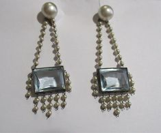 Antique/vintage Art Deco chandelier earrings circa 1930's with a bezel set faceted baguette alexandrite and genuine pearls. The very special drop earrings measure 2 1/4 inch in length and are approximately 3/4 inch at the widest part. They are a screw back style. 1 pair. Wonderful pre-owned gently used condition, ready to wear to that special occasion. These are a very versatile style that would go well with Victorian, Edwardian, flapper, Art Deco or contemporary styles. The faceted baguette ale Pearl Chandelier Earrings, Victorian Couple, Pearl Chandelier, Art Deco Chandelier, Brass Jewelry, Vintage Art Deco, Chandelier Earrings, Antique Vintage, Vintage Art