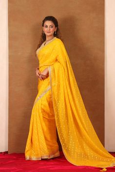 Beautiful yellow embroidered Banarasi Khaddi saree is a perfect choice for weddings and festive occasions! The saree has a beautiful embroidered border. It comes with a saree blouse. Disclaimer: The actual product may vary slightly from the image. These are custom orders, hence expect slight variation in color, placement of the motif or buta. ESTIMATED DELIVERYBecause this is a custom order, it would take about 4 weeks from the date of purchase. RETURN POLICYThis product is a custom order and cannot be returned or exchanged. Wedding Sarees, Fashion Journals, Embroidered Border, Traditional Fabric, Saree Online, Designer Sarees, Handloom Saree, Sarees Online, Blouse Dress