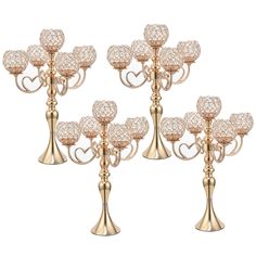 set of four crystal candle holders with hearts on each one and heart shaped candlesticks in the middle