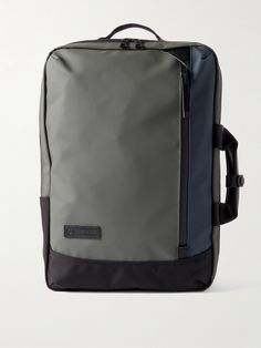 a grey and black backpack with straps on it's back pocket, sitting against a white background