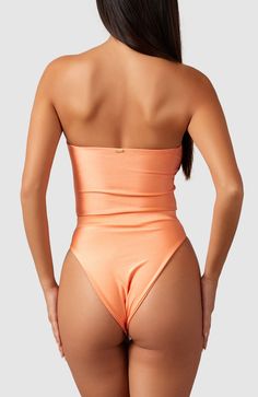 This one-piece is the perfect combination of classy and sexy. Boning and silicone elastic keep this strapless one-piece up and in place so you feel comfortable and secure. Ultra soft material, strapless, double lined Brazilian bottom coverage High cut at hips elongate the legs Elastic in waistband cinches in waist Solid Strapless Smoothing Bodysuit, Elegant Strapless Smoothing Bodysuit, Elegant Stretch Bandeau Bodysuit, Strapless Nylon Swimwear For Party, Elegant High-cut Smoothing Swimwear, Elegant Strapless Swimwear, Solid Strapless Swimwear With Smoothing Details, Elegant Seamless Swimwear For Party, Solid Strapless Smoothing Swimwear