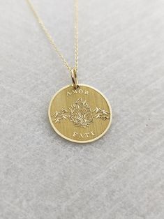 "Amor Fati Necklace - Engraved Love of Fate Charm - Gold Graduation Charm - Gold Stoic Pendant ▪️ A beautiful and clean engraved Amor Fati pendant made out of 14K Solid Real Gold. Available only in yellow gold! Pendant Thickness: 0.50mm Jump Ring inner diameter: 4mm Dimensions: - 13mm / 0.52 inches - 15mm / 0.59 inches - 18mm / 0.70 inches - 20mm / 0.78 inches - 22mm / 0.86 inches - 24mm / 0.94 inches Necklace Length - You can choose your chain length from 35CM to 50CM. The pendant is available Symbolic Engraved Jewelry For Valentine's Day, Valentine's Day Symbolic Engraved Jewelry, Spiritual 14k Gold Jewelry Stamped 14k, Symbolic 14k Gold Jewelry With Engraving Option, Symbolic Yellow Gold Jewelry With Engraving Option, Symbolic Gold Jewelry For Valentine's Day, Spiritual 14k Gold Jewelry For Anniversary, Spiritual Engraved Jewelry For Valentine's Day, Symbolic 14k Stamped Promise Jewelry