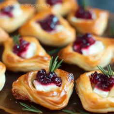 small pastries with cranberry sauce and rosemary sprigs