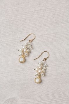 Experience the beauty and craftsmanship of the Seaside Collection with these gorgeous handmade earrings.    Mixed Metal (lead and nickel free) Pearl 1.5", with gold filled ear wires We hand select our natural materials, thus there may be slight variations in color and/or size that will not detract from the overall aesthetic Our unique handcrafted designer jewelry for women is made in America, with each design created individually in our personal design studio in Floyd VA USA Gold Wire Wrapped Earrings For Wedding, Handmade White Chandelier Earrings For Anniversary, Elegant Gold Wire Wrapped Beaded Earrings, Elegant Brass Wire Wrapped Earrings, Delicate Gold Wire Wrapped Earrings, Elegant Gold Beaded Hypoallergenic Earrings, Dainty Chandelier Earrings As Gift, Elegant Adjustable Brass Beaded Earrings, Elegant Gold Hypoallergenic Beaded Earrings