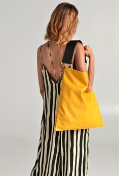 Akathi mat bag in yellow. A beautiful large hobo bag which is ideal for every day use. Not just a shoulder bag, a statetment tote which can easily be used as a shopper bag, even as a beach bag. It's loose minimalistic look makes it modern and unique. Handmade in our studio from lux italian cow yellow leather and a premium cow leather for the strap in black. Big rectangular metal loops in gold or silver are used to connect the strap with the bag and a metal swivel clasp is added in the interior f Modern Yellow Shoulder Bag For On-the-go, Modern Yellow Bag For Errands, Summer Leather Hobo Bag, Chic Yellow Shoulder Bag, Chic Yellow Shoulder Bucket Bag, Modern Yellow Shoulder Bag For Errands, Chic Yellow Bags With Double Handle, Chic Yellow Bag With Double Handle, Yellow Top Handle Shoulder Bag For Errands