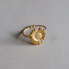 Discover our ring with a delicate sunflower - an enchanting accessory that underlines your style with natural elegance. Made in the elegant color gold and adjustable, it is made of high-quality stainless steel. Opt for customizable elegance and a fresh touch with this special ring. Dainty Adjustable Jewelry For Spring, Dainty Adjustable Spring Jewelry, Adjustable Dainty Spring Jewelry, Resizable Jewelry As A Spring Gift, Elegant Adjustable Sunflower Design Jewelry, Elegant Adjustable Sunflower Jewelry, Resizable Jewelry Gift For Spring, Adjustable Stainless Steel Stackable Rings, Delicate Gold Flower Ring For Spring