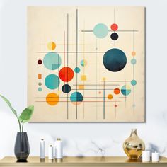 an abstract painting hangs on the wall above a table with candles and vases in front of it