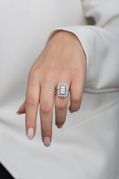 a woman's hand with a diamond ring on it