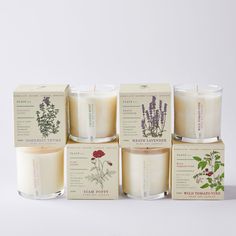 six candles with different types of flowers on them