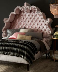 a bedroom with a pink headboard and bed