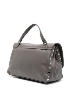 This charming little number is your new everyday companion, blending effortless style with practical versatility. Its sleek design and chic details make it perfect for any occasion, whether you're heading to brunch or a night out. Trust me, you'll wonder how you ever lived without it. Charcoal grey calf leather with a grained texture Silver-tone stud detailing and hardware Foldover top with twist-lock fastening Single flat top handle Adjustable, detachable shoulder strap Partitioned compartment Grey Shoulder Bag, Leather Cap, Crossbody Tote, Beach Tote Bags, Handbag Backpack, Leather Tote Bag, Leather Accessories, Bago, Clutch Handbag